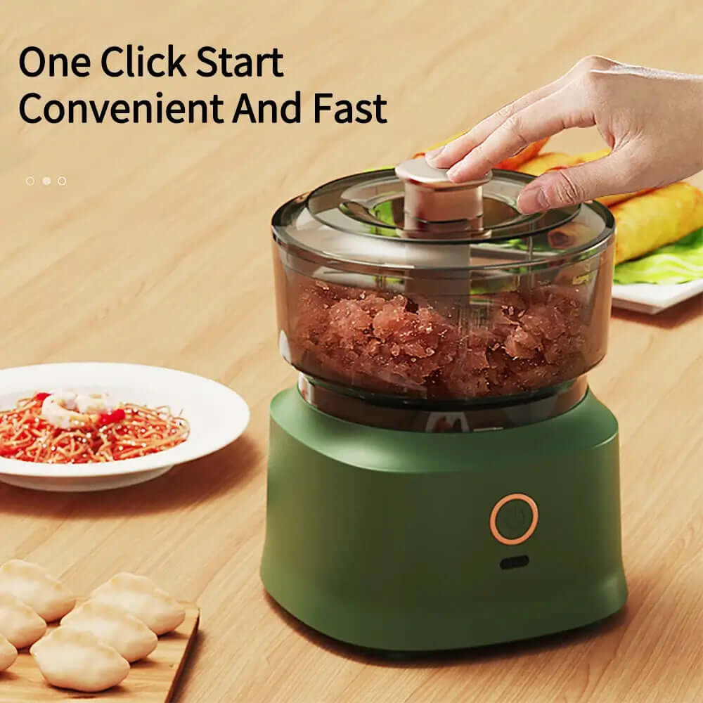 The mini electric meat grinder mincer machine in green, containing blended meat, showcasing its convenient 1 click start.