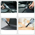 4 images of the wireless car vacuum cleaner with its different attachable heads, being used on various surfaces and devices. A drinks holder in a car, a car seat, laptop and desk.