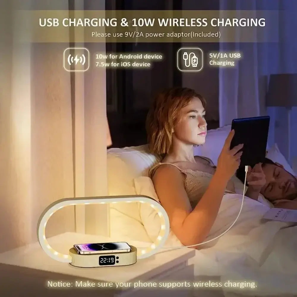 The wireless charger night light charging s phone wireless and an iPad via the USB while a women is in bed using it, next to a sleeping man.